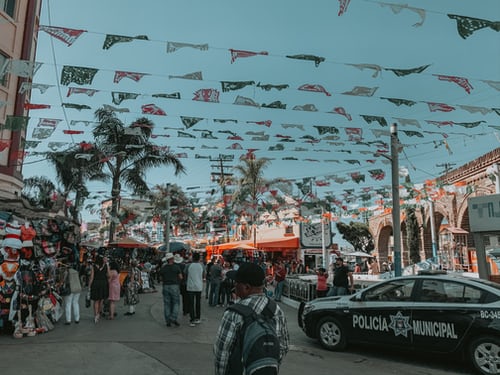 : A busy street in Tijuana, Mexico, with a police car