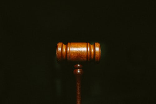 A judge’s gavel over a black background