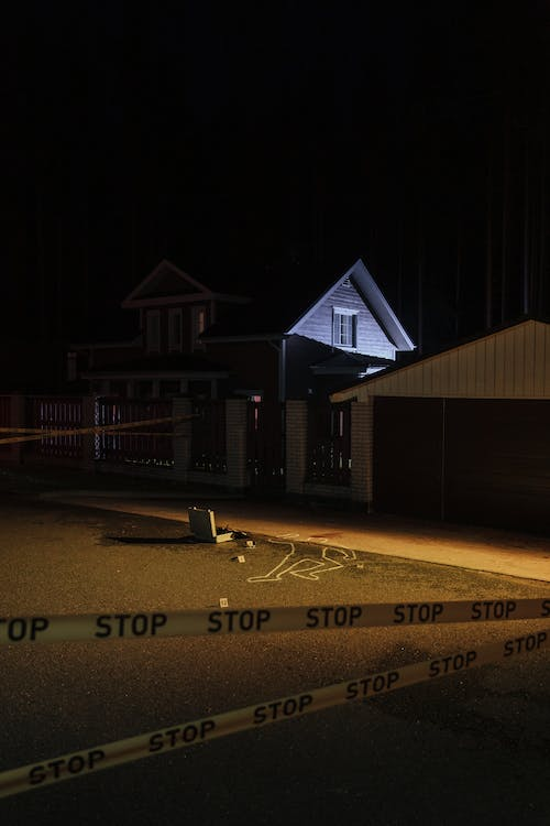 Police tape surrounding a crime scene outside a home