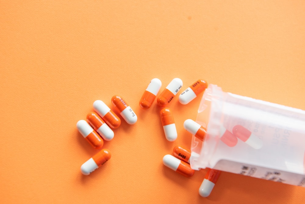orange and white medicinal pills